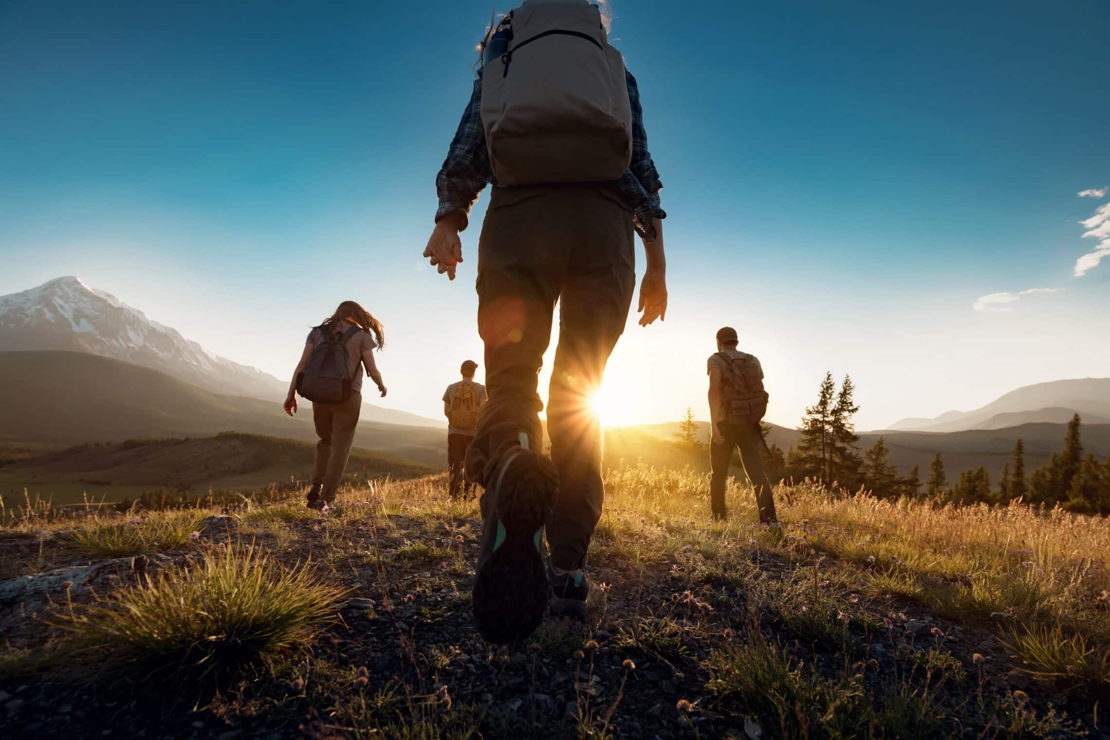 Group,Of,Sporty,People,Walks,In,Mountains,At,Sunset,With